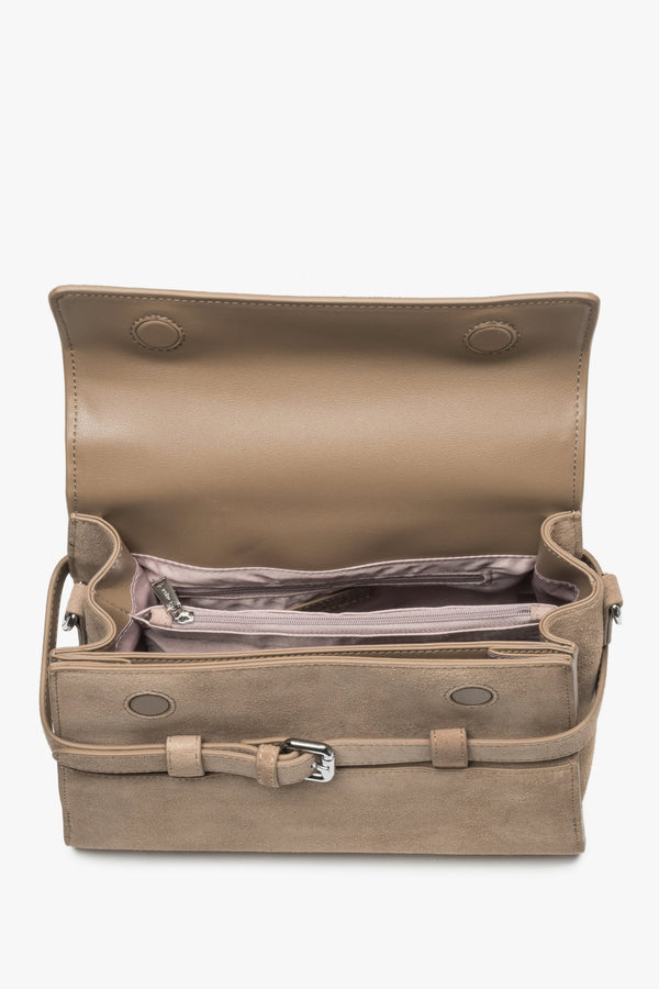 Interior view of women's beige velour shoulder bag with compartments