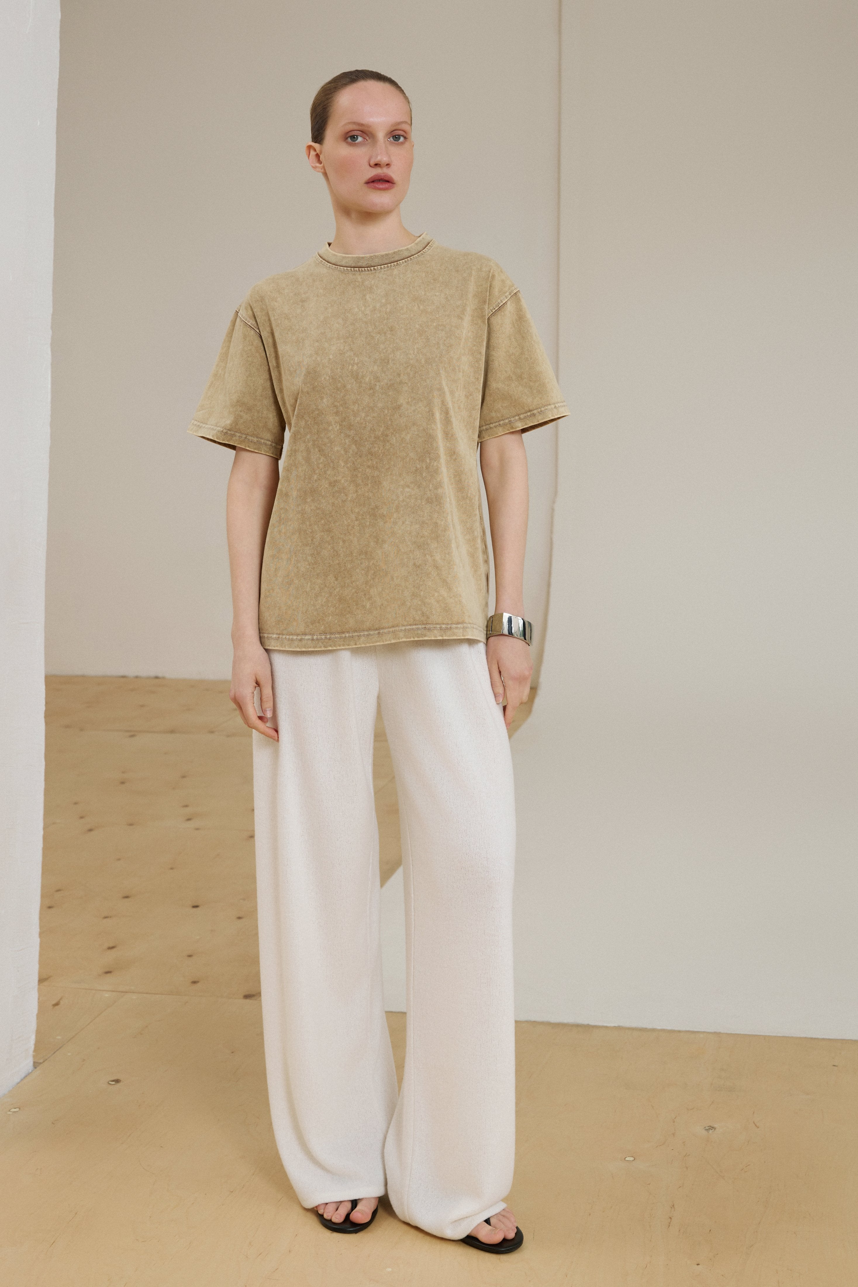 Model wearing beige washed-effect boxy-cut T-shirt.