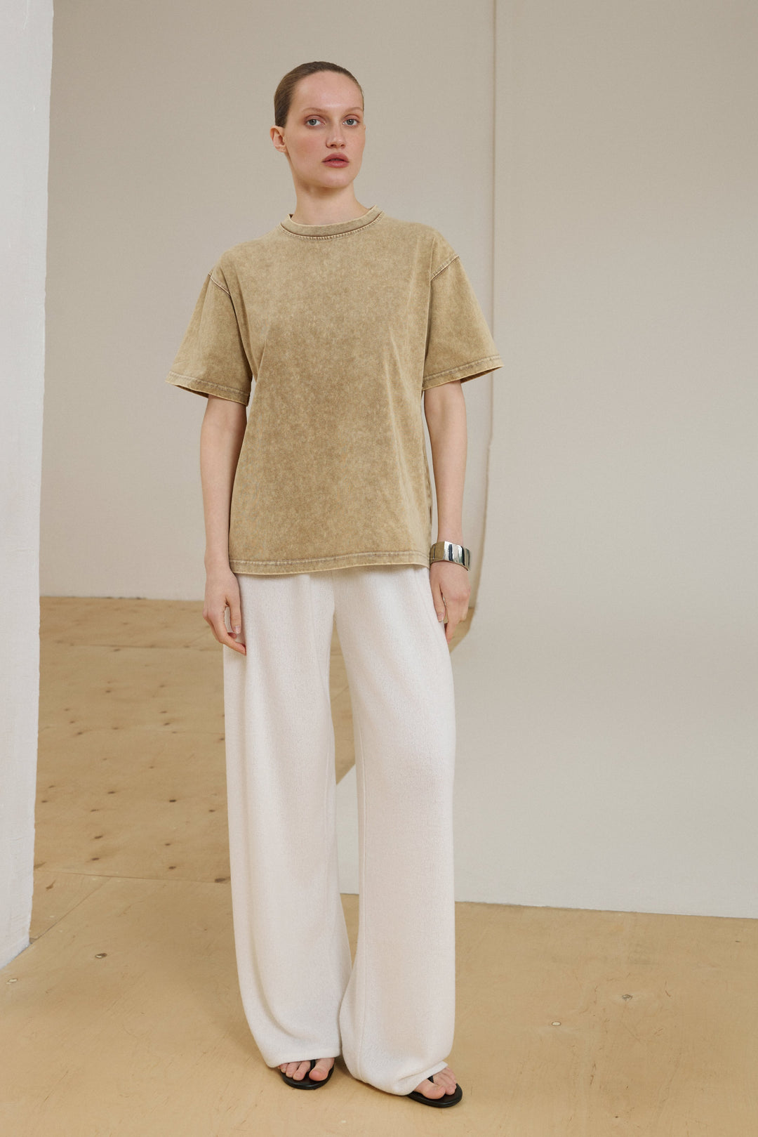Model wearing beige washed-effect boxy-cut T-shirt.