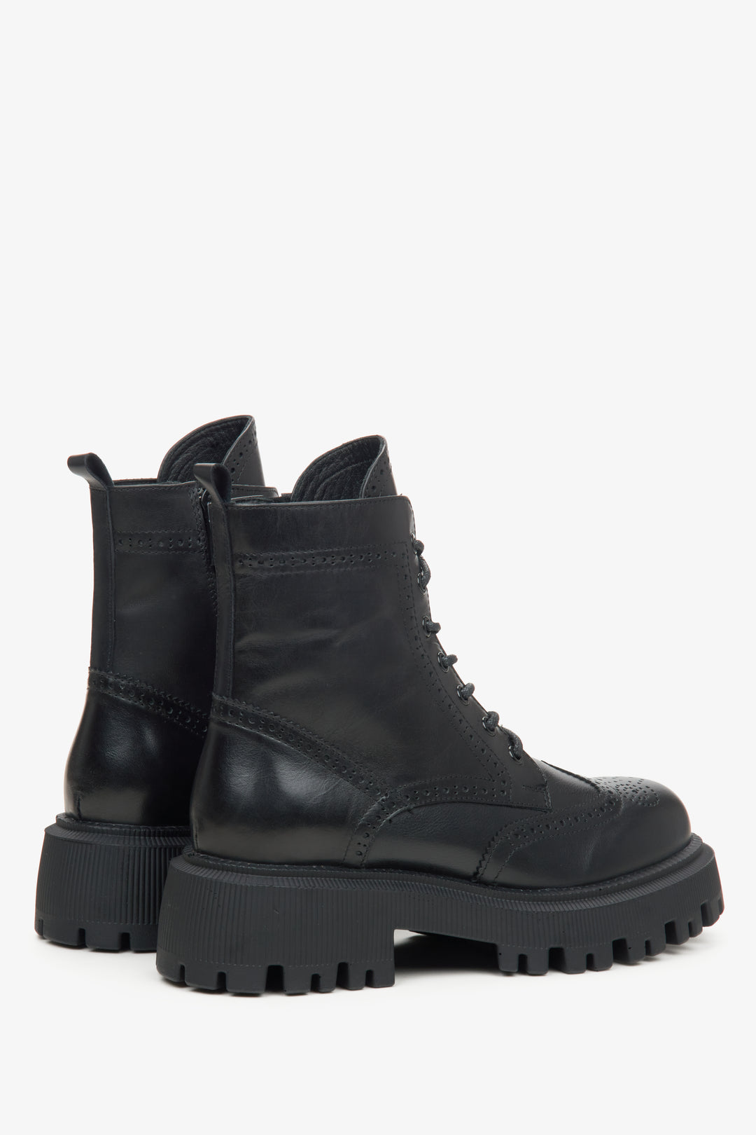 A pair of black leather lace-up ankle boots with chunky lug soles.