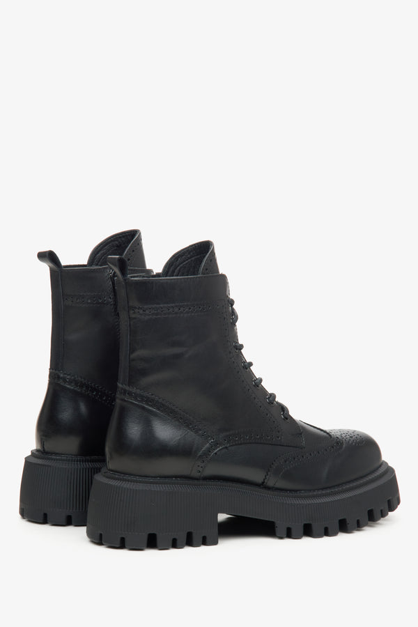 A pair of black leather lace-up ankle boots with chunky lug soles.
