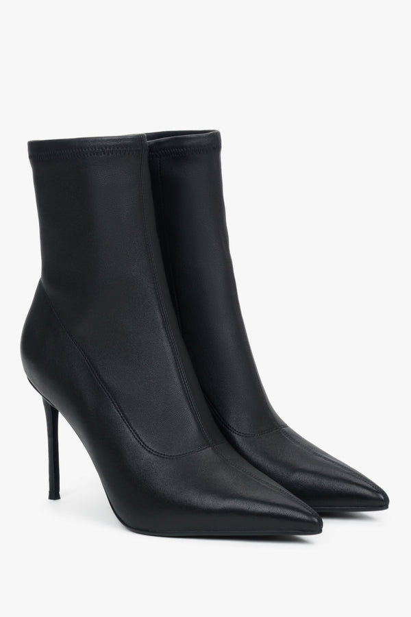 Women’s black ankle boots with an elastic shaft on a high stiletto heel.