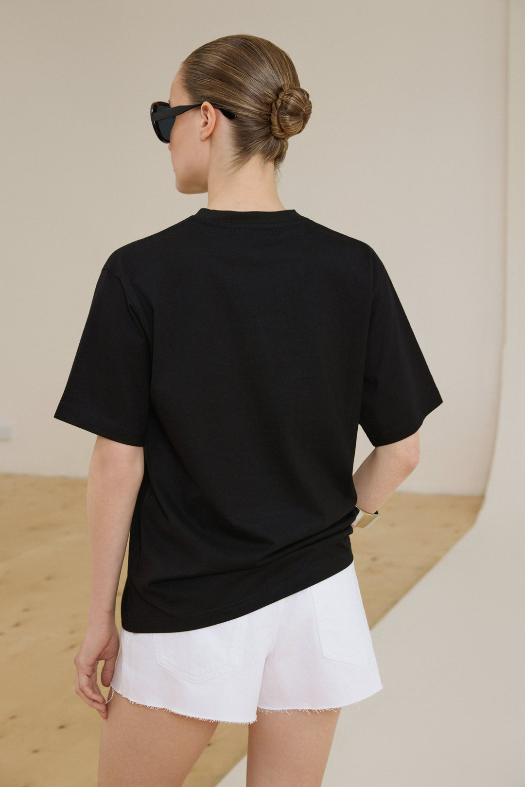 Oversized boxy-cut black T-shirt by Estro.