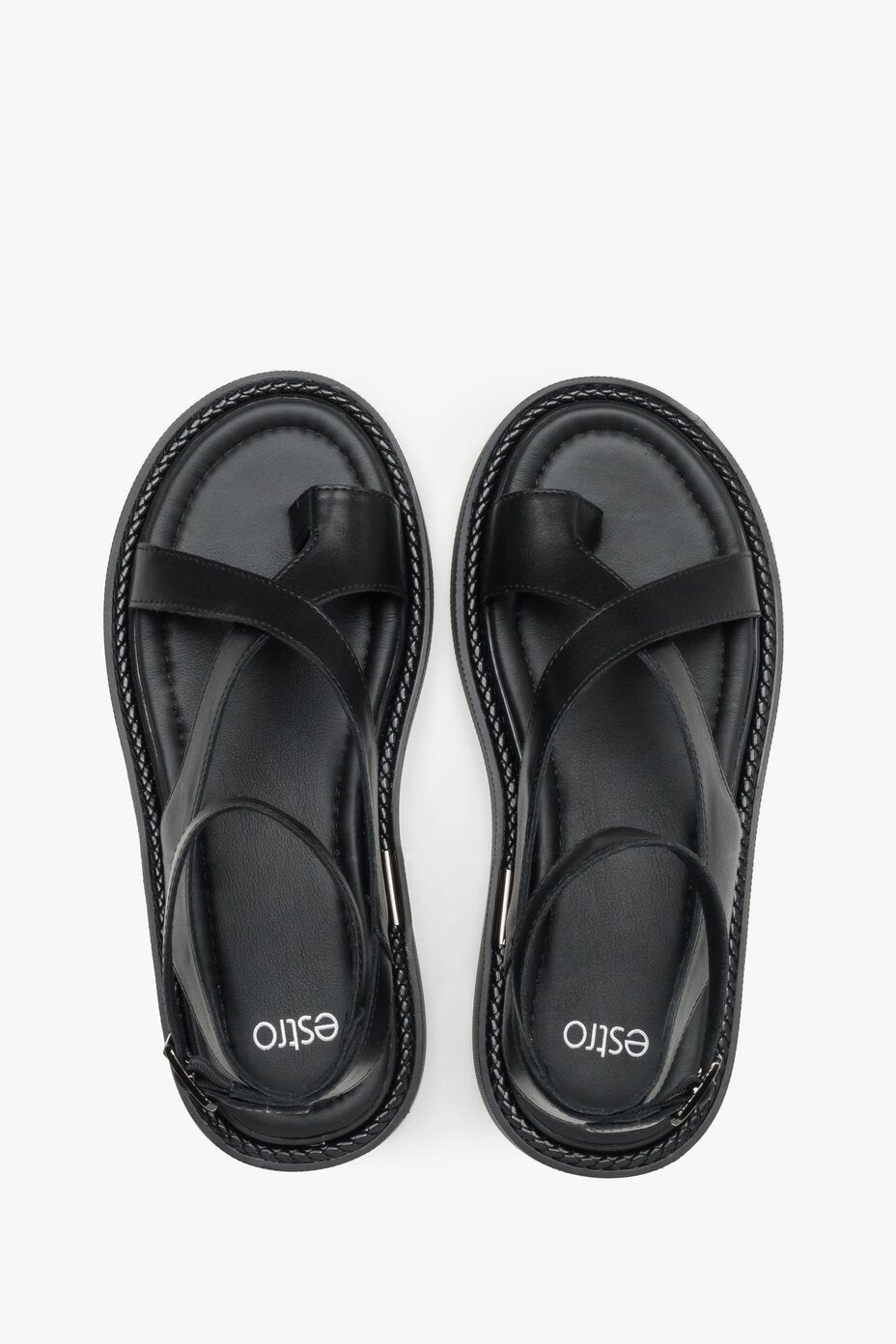 Black leather sandals with a thick sole for comfort and stability.