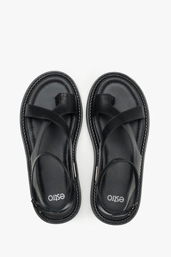 Black leather sandals with a thick sole for comfort and stability.