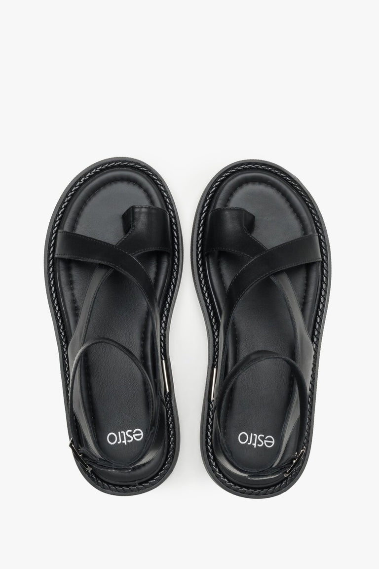 Black leather sandals with a thick sole for comfort and stability.