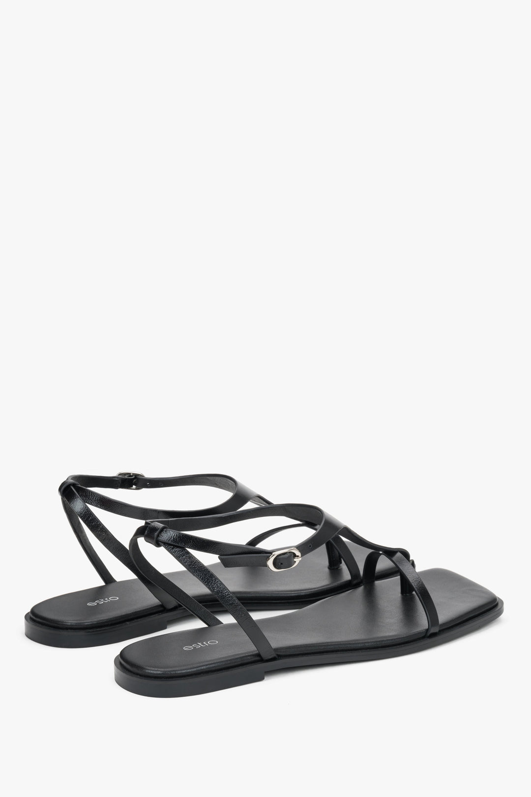 Women’s black flat sandals by Estro with a square toe and a toe-post strap.