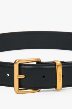 Women's black leather belt with a gold buckle, Estro.