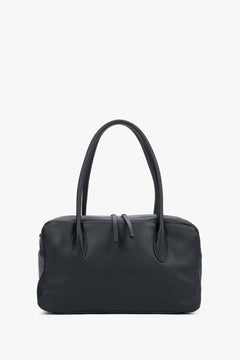 Black genuine leather bowling bag featuring sturdy top handles and an adjustable shoulder strap, Estro.