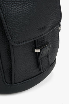 Women's black leather bucket backpack Estro - side view showing shoulder straps and side profile.