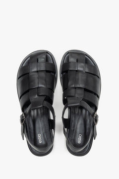 Women's flat black leather sandals in a classic fisherman style.