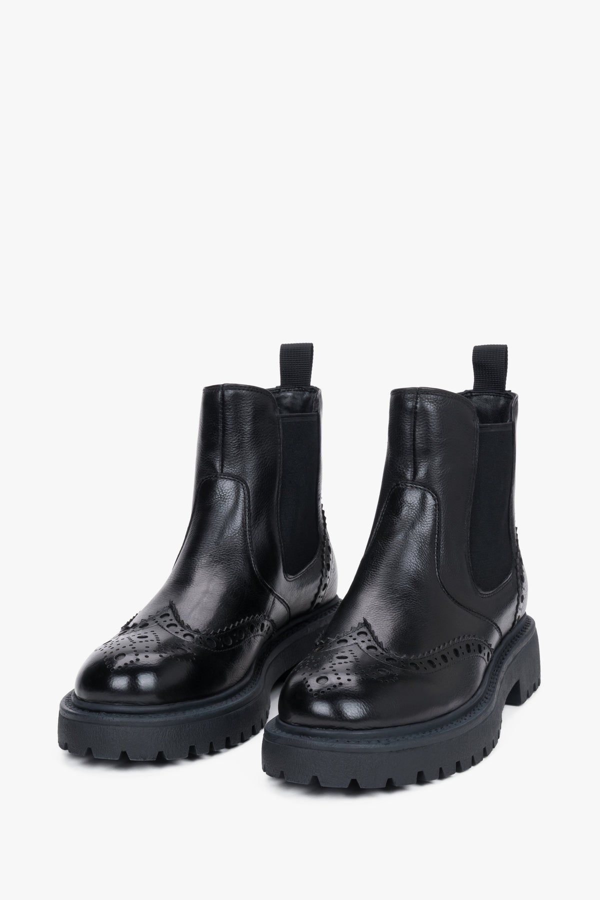 Estro - women's black leather Chelsea boots on a thick sole with brogue perforation.