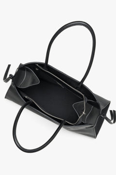 Women's black leather bowler bag Estro - close-up of side lacing and craftsmanship details.
