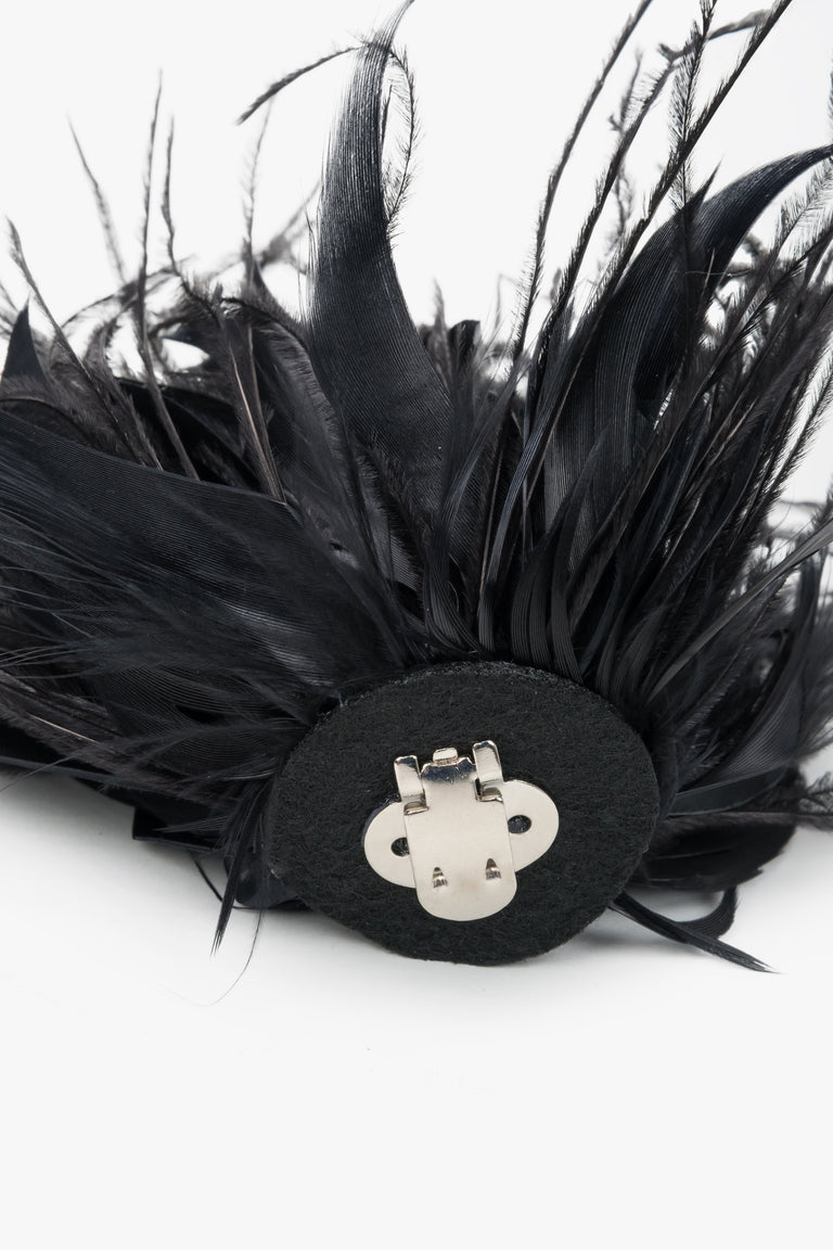 Close-up of detachable black feather trim for high heel sandals