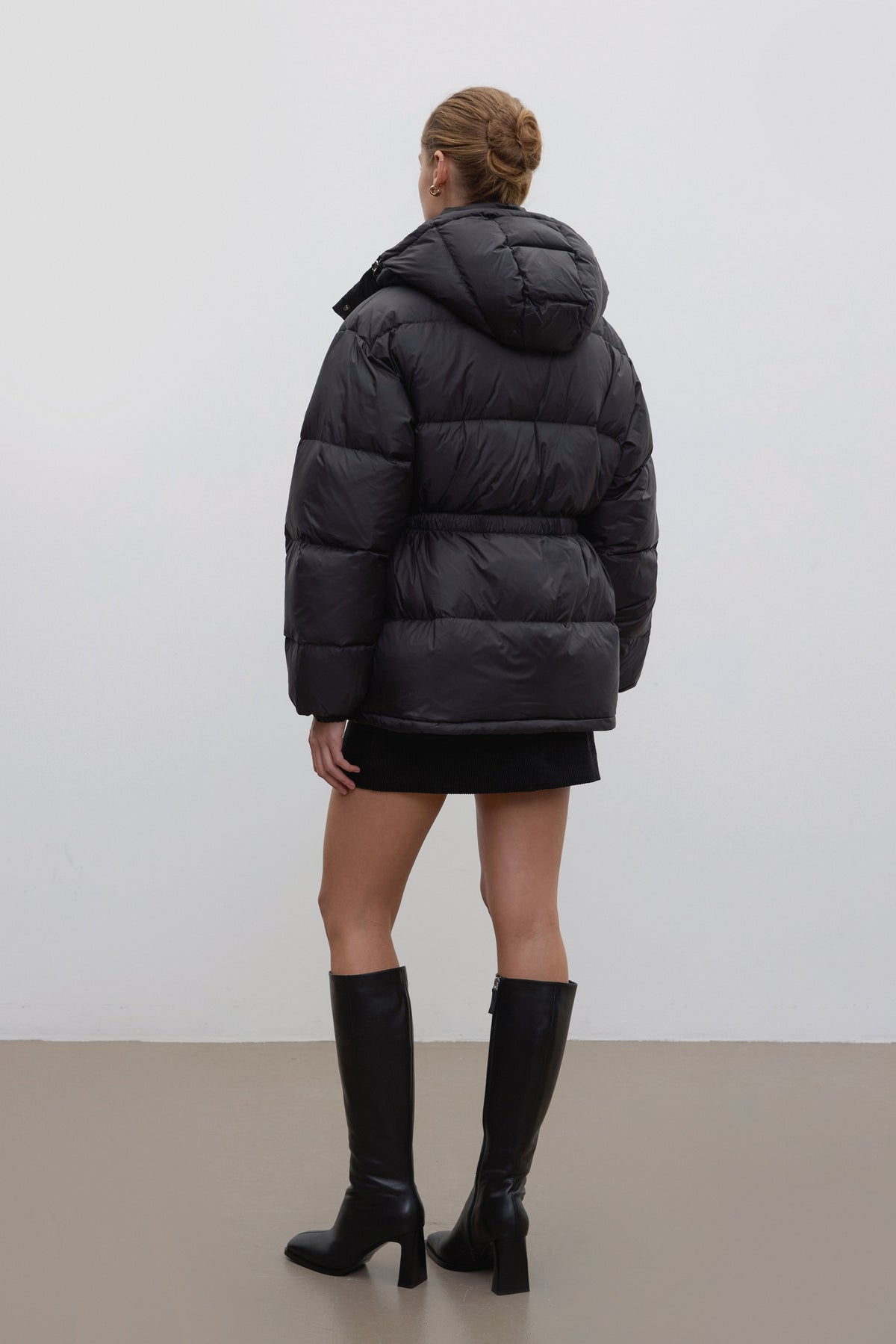 Black hip-length women's jacket with goose down and belt.