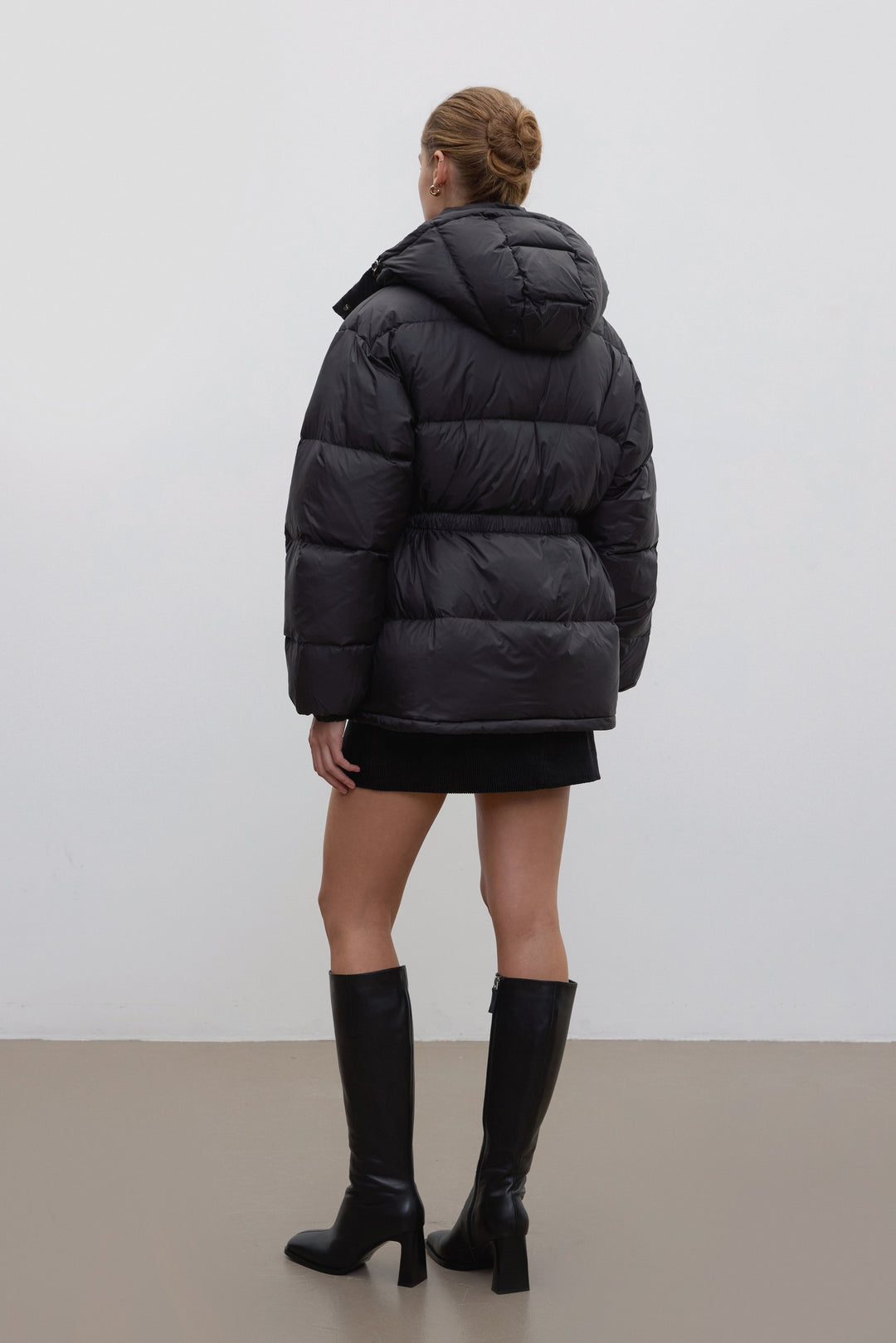 Black hip-length women's jacket with goose down and belt.