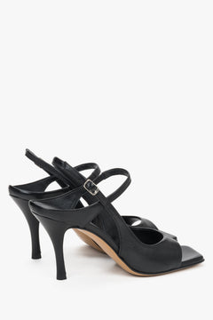 Close-up of the premium leather texture and stable heel design on black evening sandals.