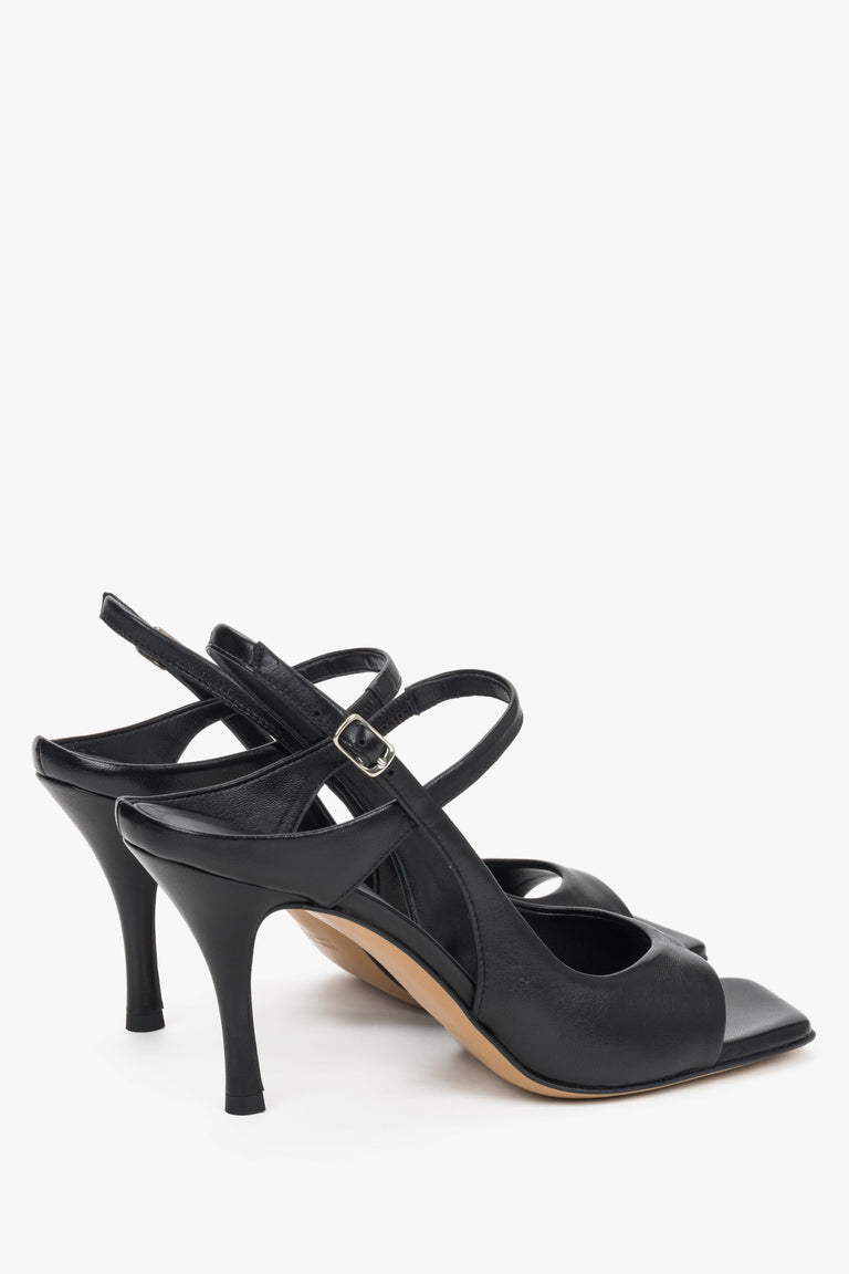 Close-up of the premium leather texture and stable heel design on black evening sandals.