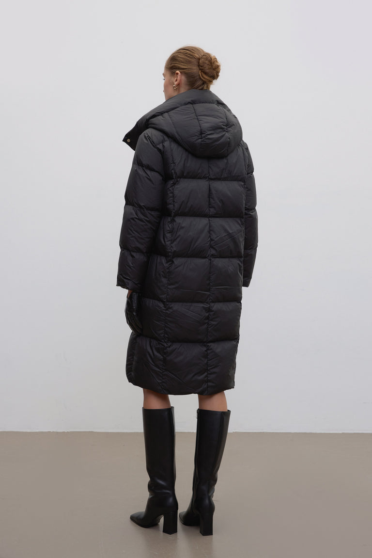 Women’s black knee-length winter jacket by Estro.