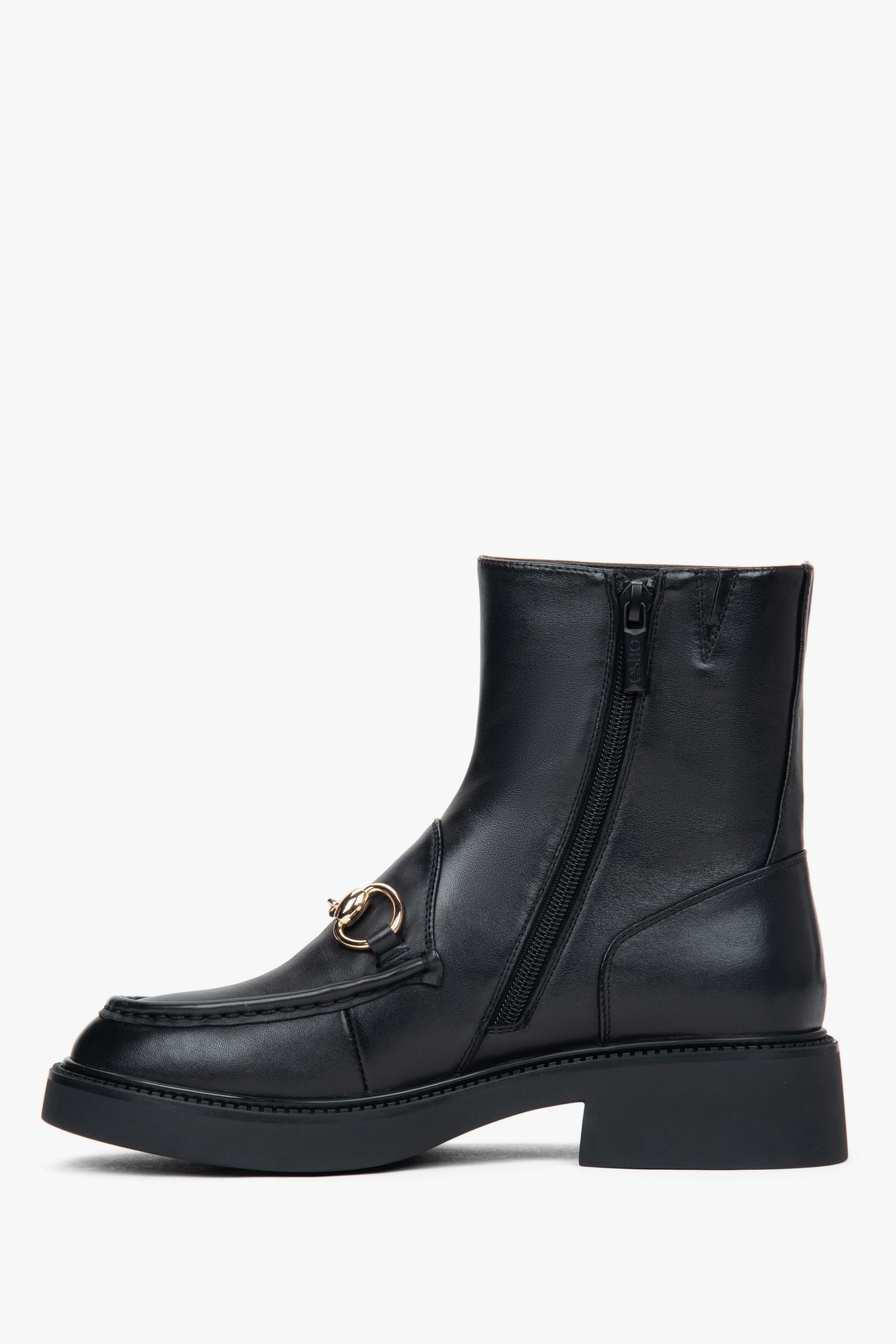 Women’s black leather ankle boots with a decorative buckle – side view.