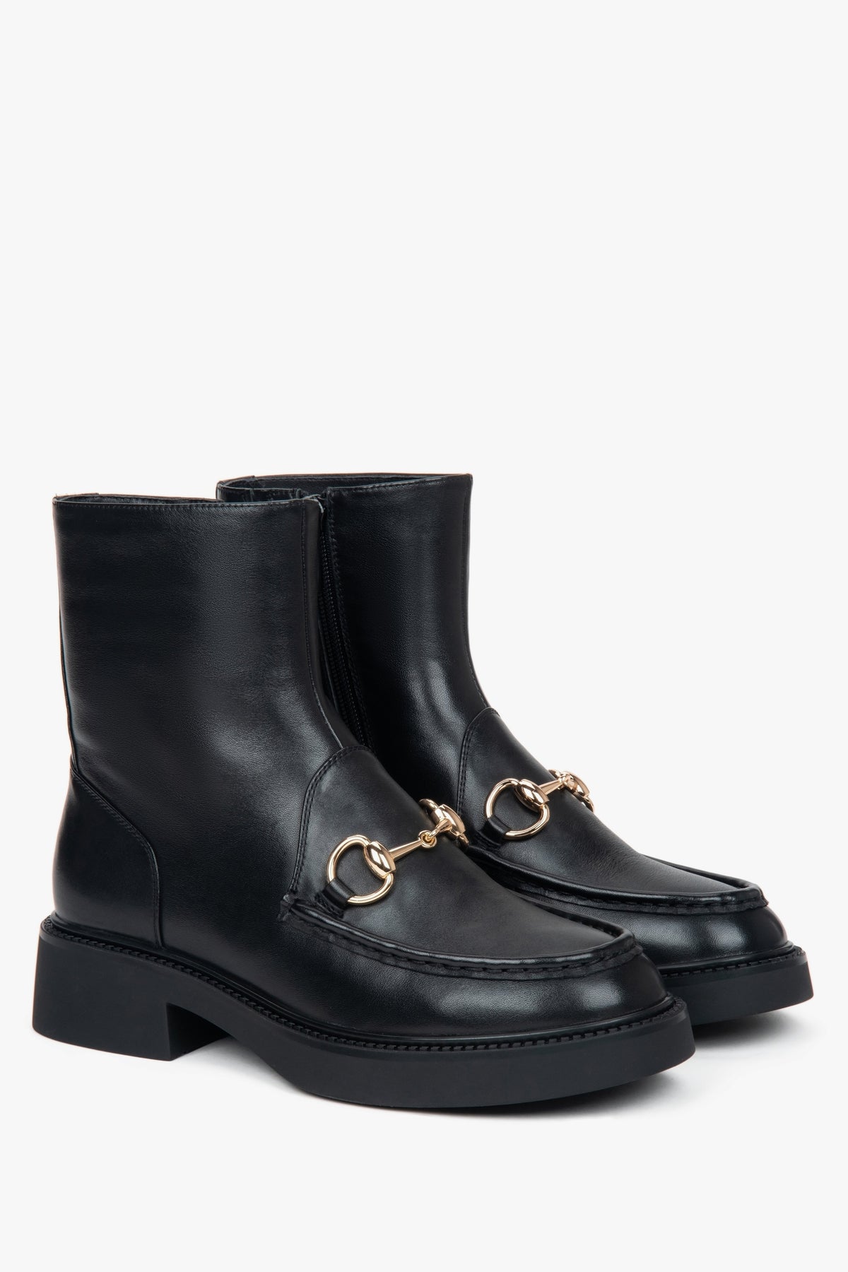 Women’s black leather ankle boots with a decorative buckle by Estro.