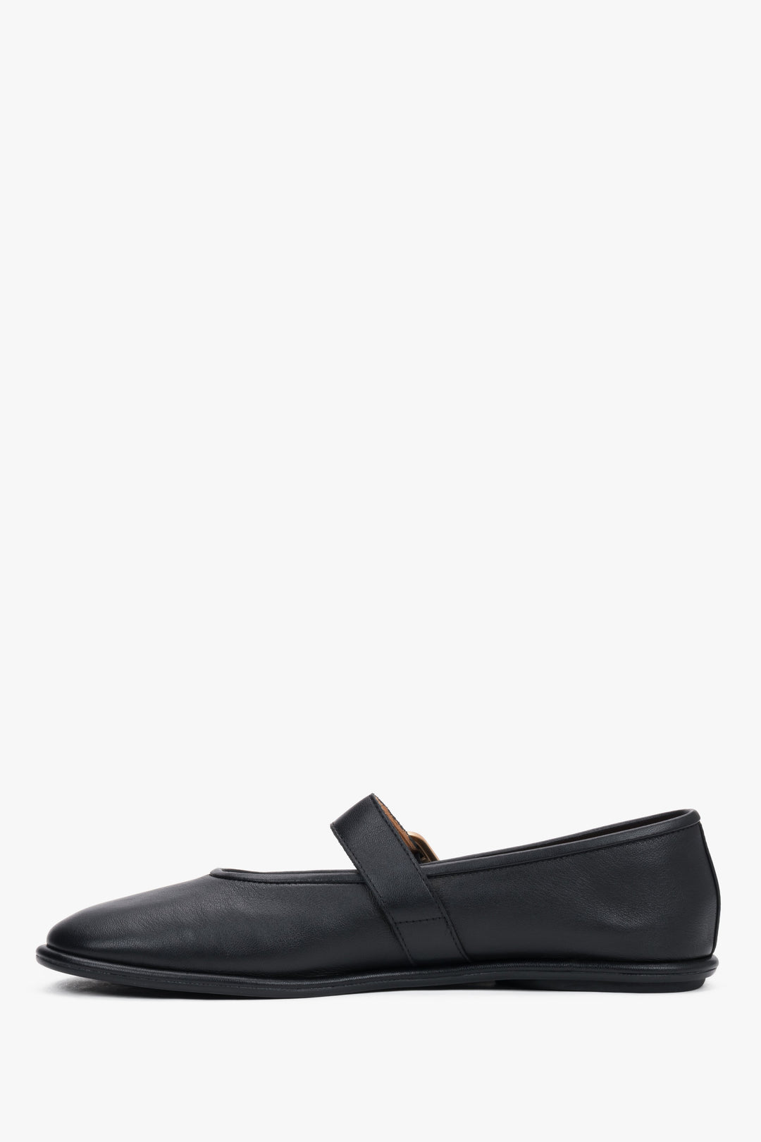 A profile shot of the black leather ballet flats highlighting the slim, flat rubber sole and the elegant positioning of the adjustable ankle strap.