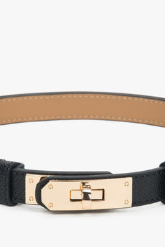 Women's black leather belt with a gold buckle.