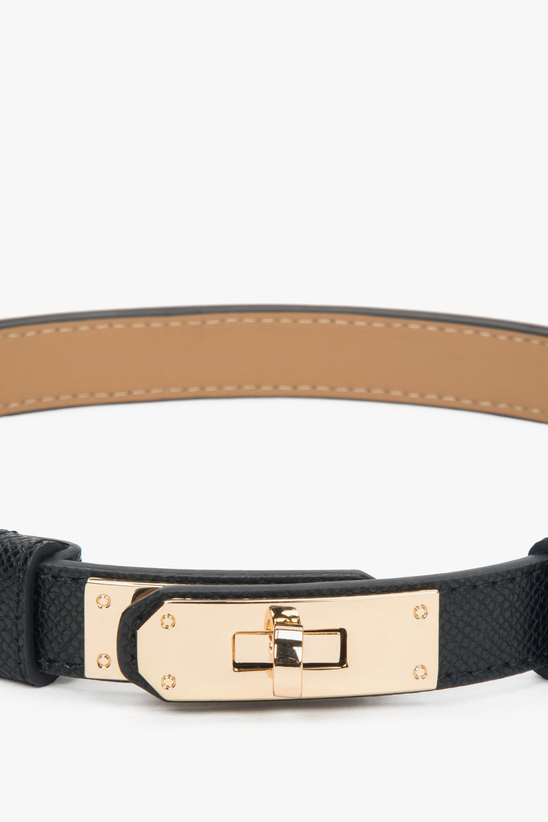 Women's black leather belt with a gold buckle.