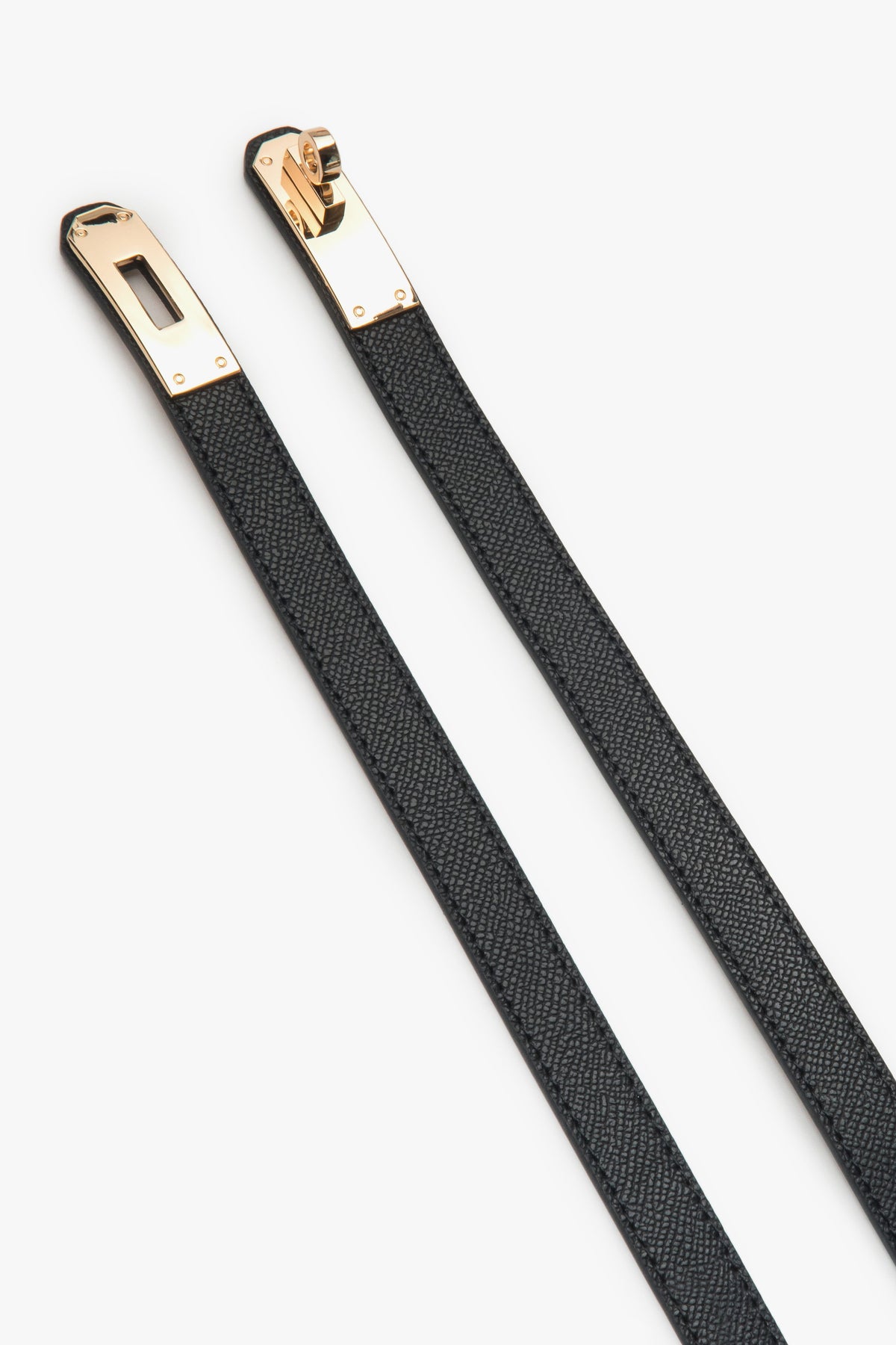 Black women's leather belt with a gold buckle.