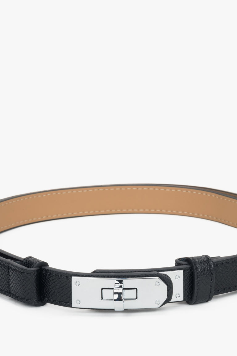 Women's black leather belt with a silver buckle.