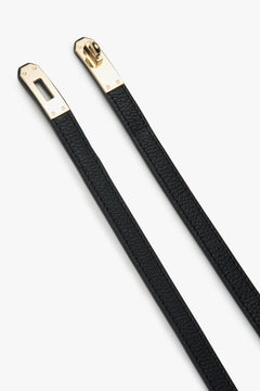 Elegant black leather belt from Estro, measuring 95 cm in length, shown styled around the waist to complement a chic outfit.