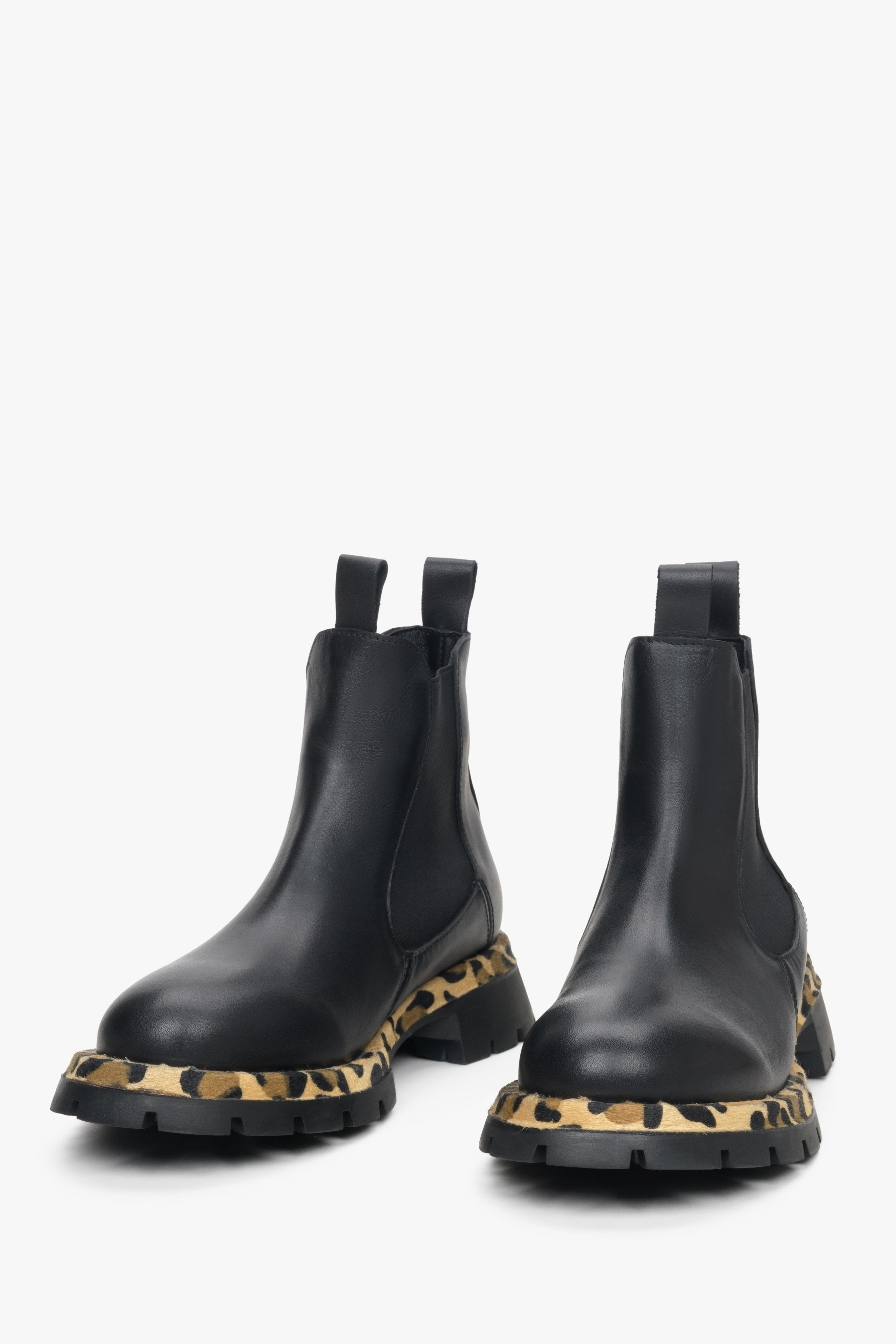 Women's black leather low-cut chelsea boots.