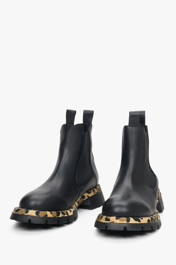 Women's black leather low-cut chelsea boots.