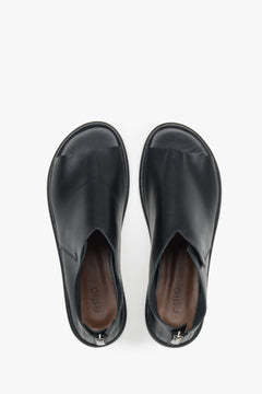 Stylish black leather sandals for women, featuring a closed-heel design for a refined and polished look.