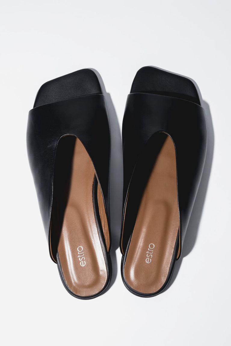 Top view of women's black leather flat mules with square toe by Estro