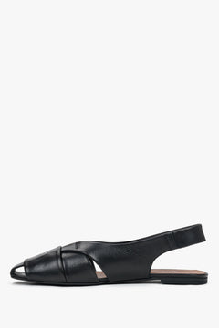 Profile of black leather sandals with open heel and flat sole.