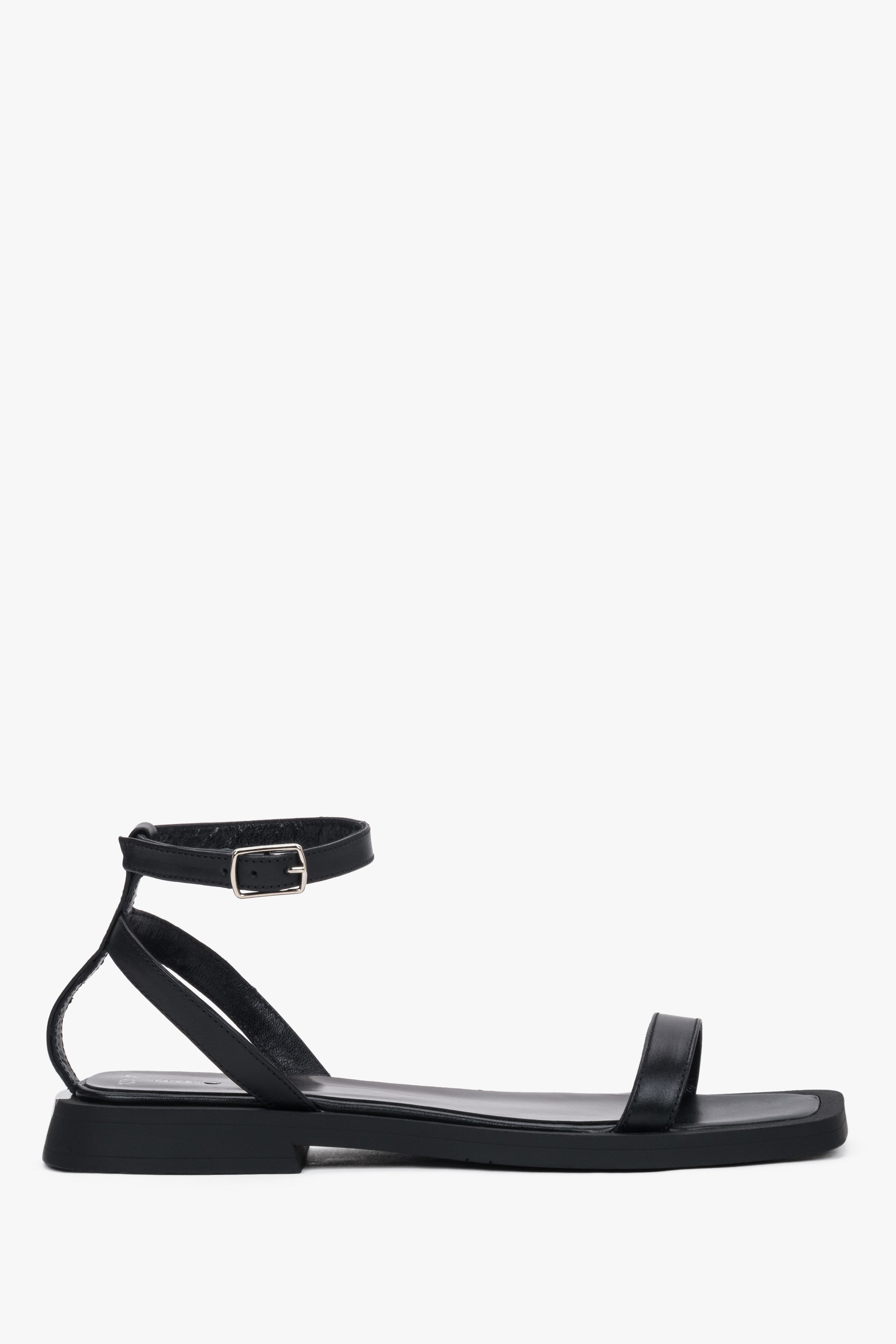 Women’s black leather flat sandals by Estro with thin straps.