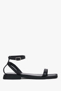 Women’s black leather flat sandals by Estro with thin straps.