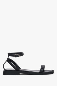 Women’s black leather flat sandals by Estro with thin straps.