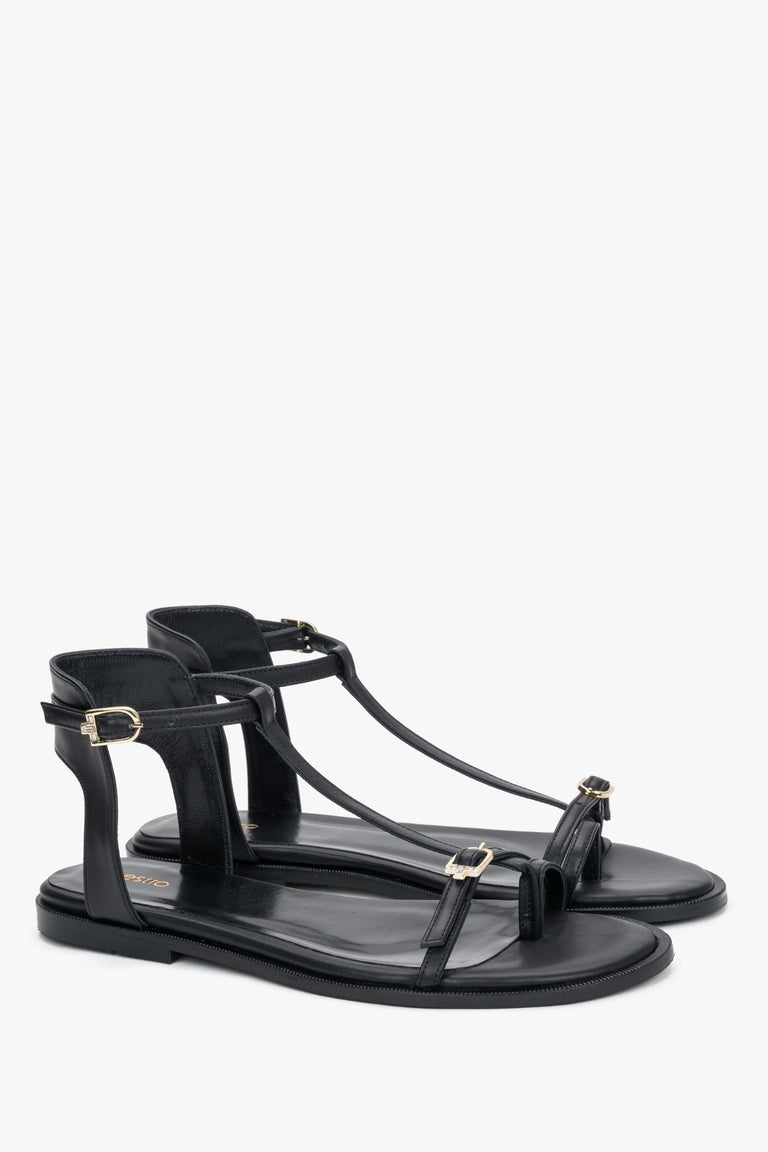 Women's black leather sandals with gold buckles and toe loop