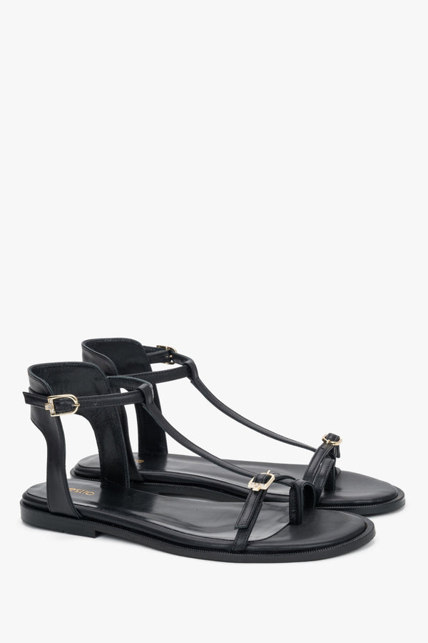 Women's black leather sandals with gold buckles and toe loop