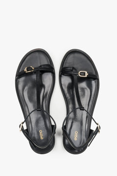 Top view of women's black leather flat sandals by Estro