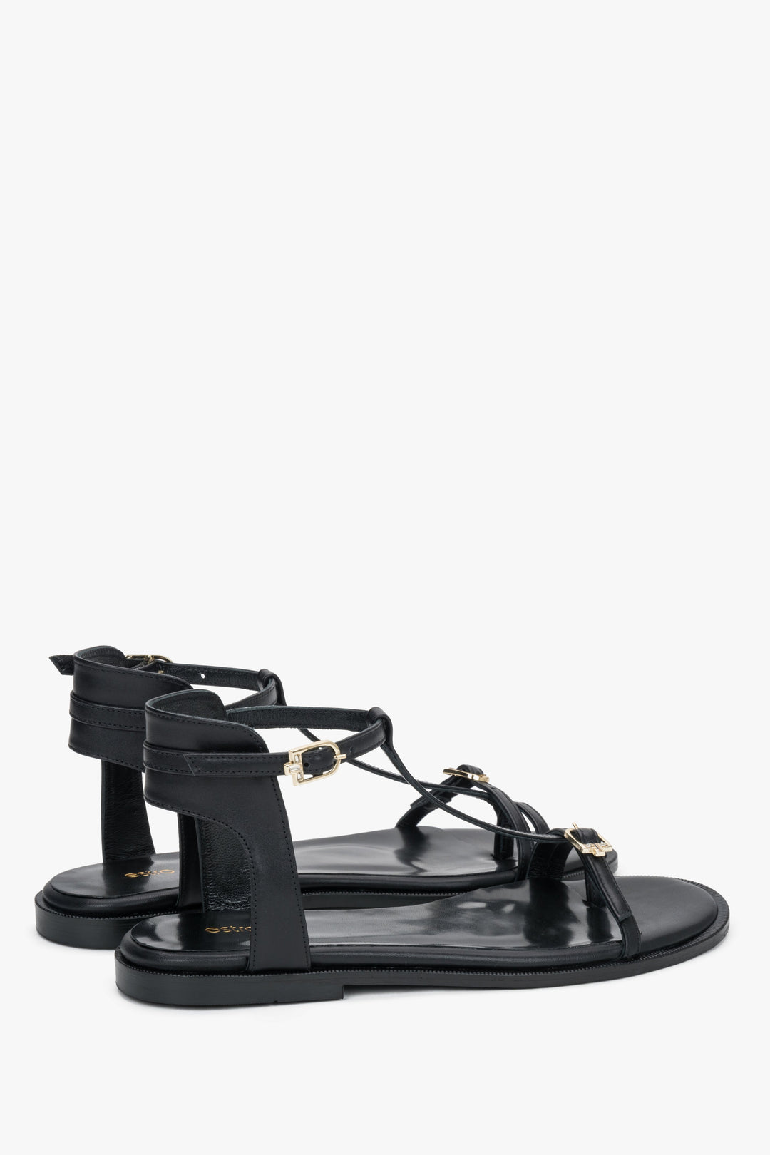 Angled view of women's black leather sandals with flexible TPU sole