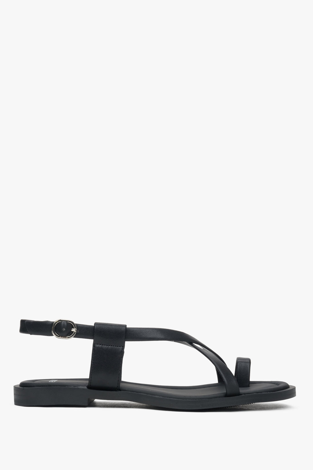 Black women’s leather sandals on a flat sole with a toe loop – side view.