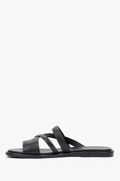 Elegant black genuine leather flat slides with a comfortable toe ring.