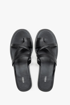 Women's minimalist black leather sandals with soft interwoven straps.