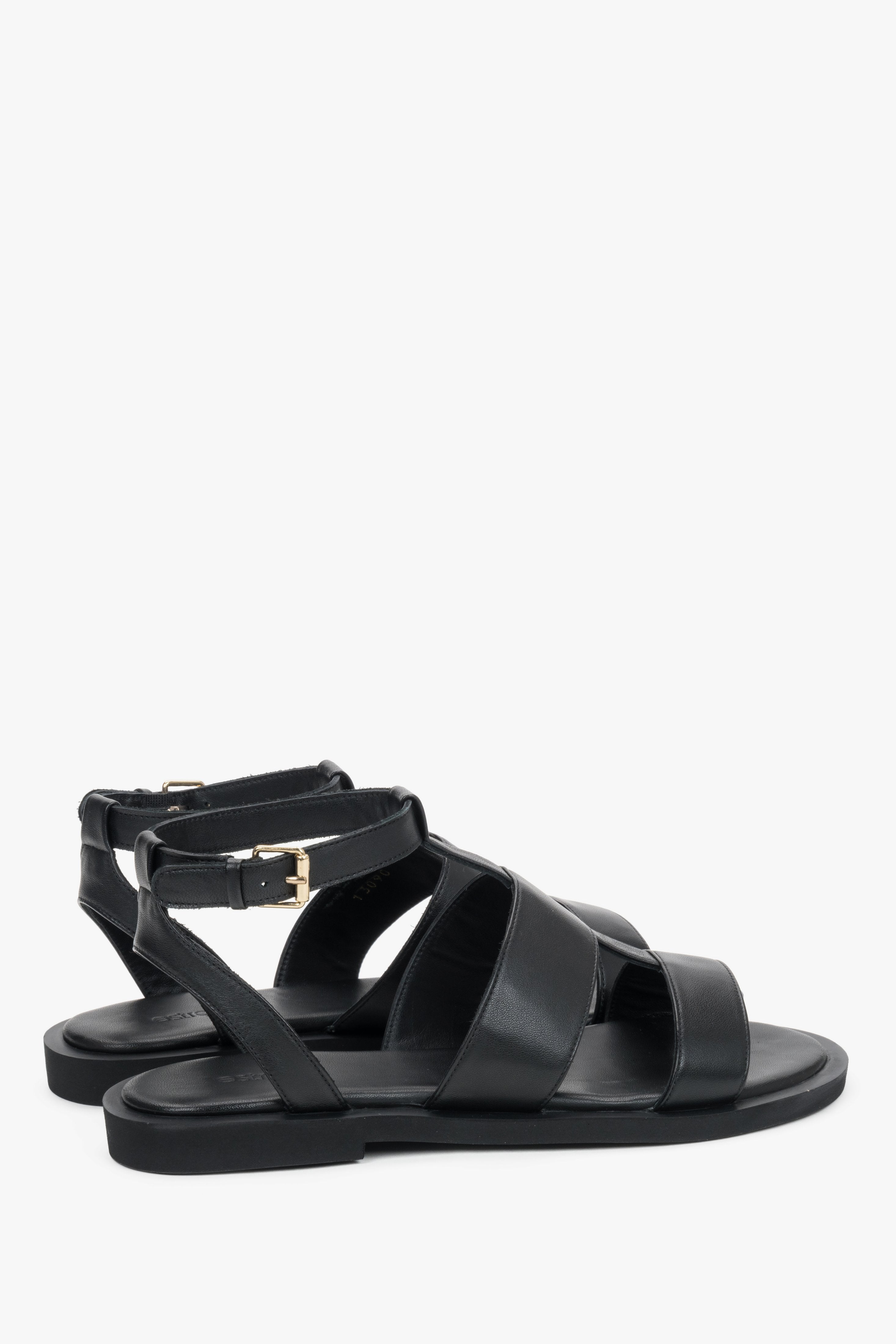Close-up of the bold leather straps and high-quality stitching on urban black sandals.