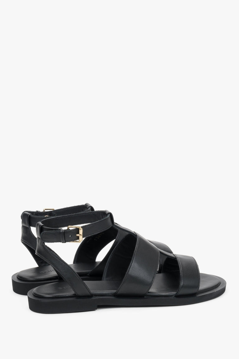 Close-up of the bold leather straps and high-quality stitching on urban black sandals.