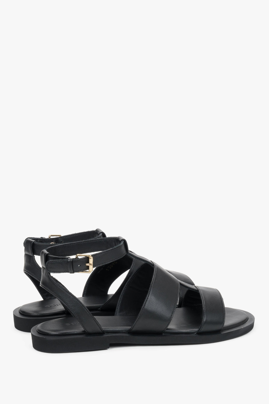 Close-up of the bold leather straps and high-quality stitching on urban black sandals.