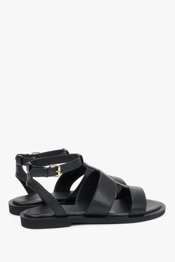 Close-up of the bold leather straps and high-quality stitching on urban black sandals.